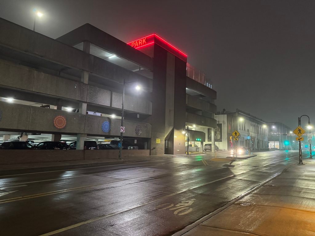 A parking ramp, labeled with a neon red sign: "PARK"